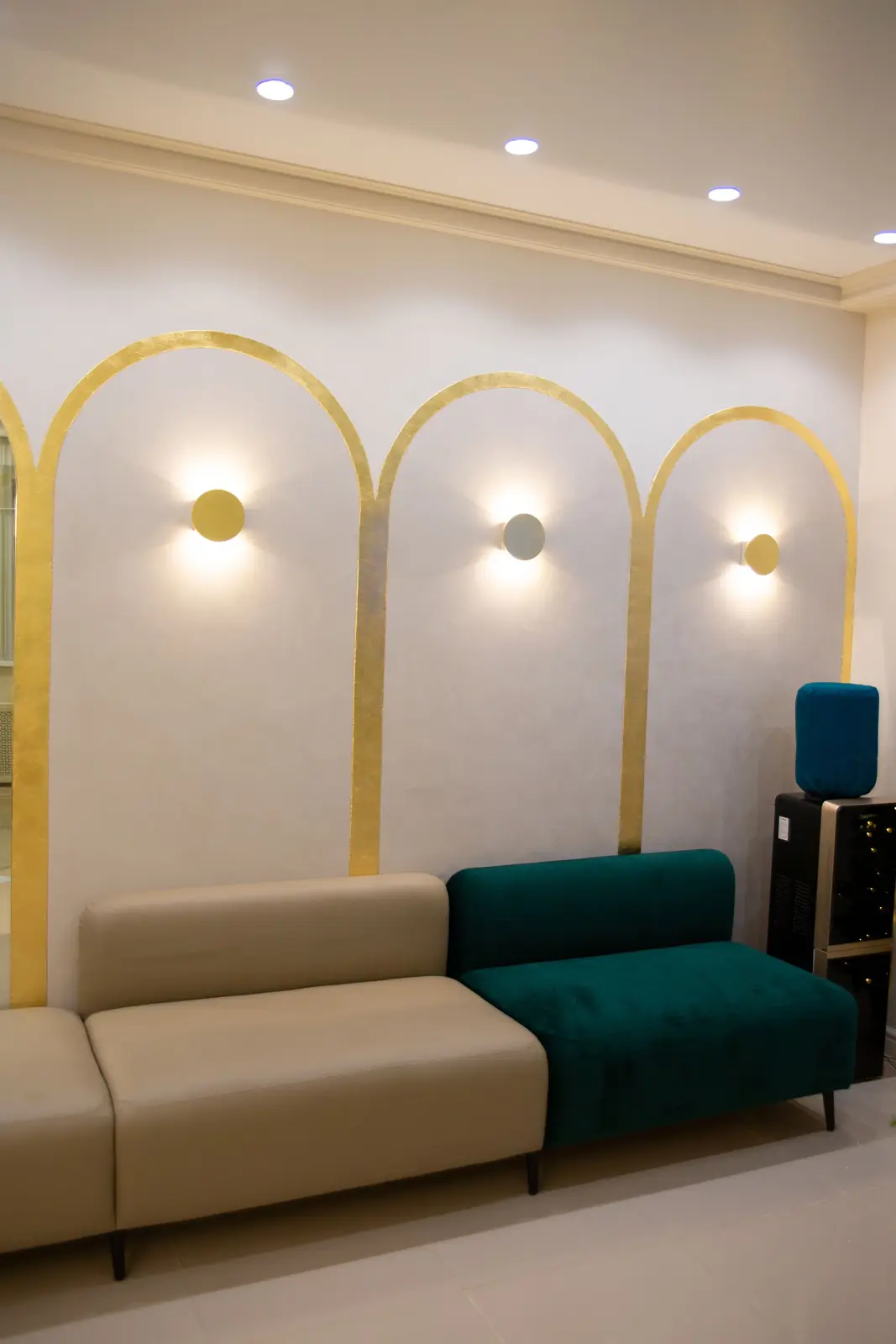 Stylish interior featuring elegant sofas under modern wall lighting design.