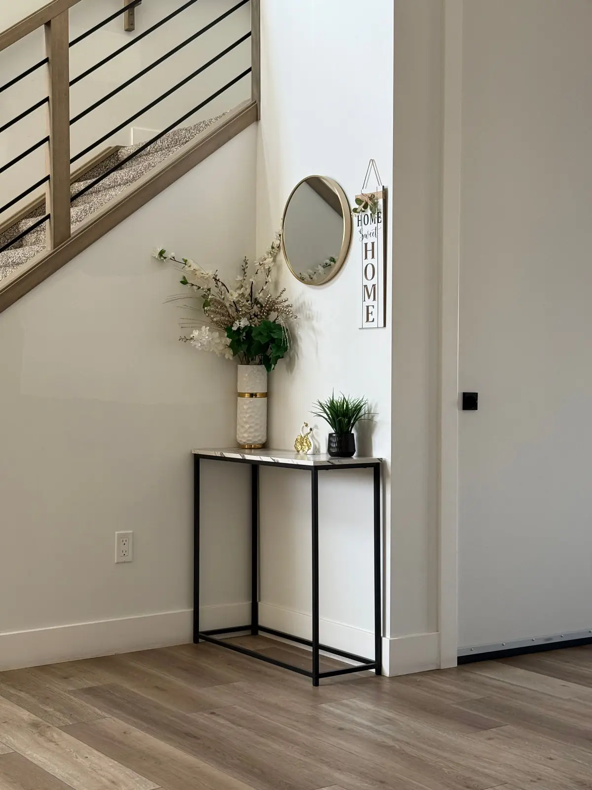 Stylish home entryway featuring a minimalist console table with decorative items.